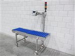 Roller conveyor with weighing zone and weighing indicator